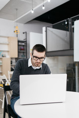 Man sitting on office table with computer