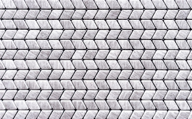 Gray mosaic tiles are laid out in the shape of a herringbone.