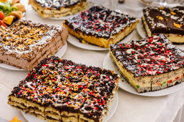 Chocolate cakes decorated with sprinkles. Portions of chocolate dessert