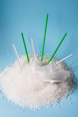 plastic utensils and straws for cocktail in granules of plastic. Polypropylene