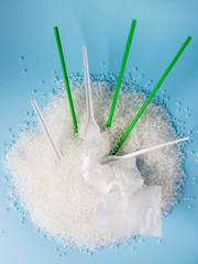 plastic utensils and straws for cocktail in granules of plastic. Polypropylene