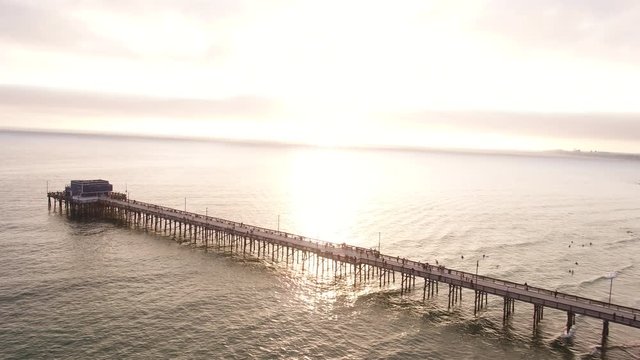 Sunset over Newport Beach pier, wide aerial