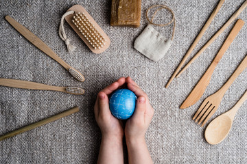 Fototapeta na wymiar Bamboo utensils cutlery set and a ball in the form of a planet that holds a child in his hands