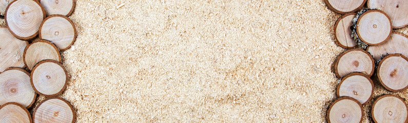 Sawdust and cut wood - concept for DIY, woodworking, home improvement and carpentry backgrounds - in a long panorama / banner / header for design.