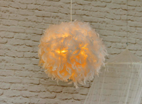 Modern lamp with abajur made of white feathers