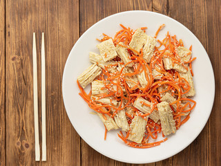 Spicy Chinese or Korean Yuba tofu bamboo and carrots salad on wooden background
