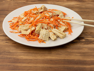 Spicy Chinese or Korean Yuba tofu bamboo and carrots salad on wooden background