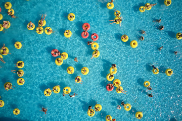 Top view - young people relax in swimming pool at bubble bath.