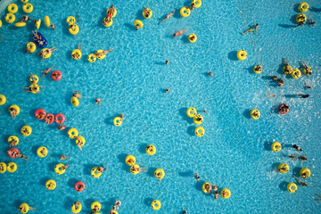 Belarus, Minsk - August 19, 2019. Waterpark. Top view - young people relax in swimming pool at bubble bath.