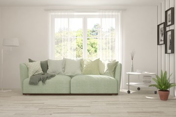 Minimalist living room in white color with sofa and summer landscape in window. Scandinavian interior design. 3D illustration