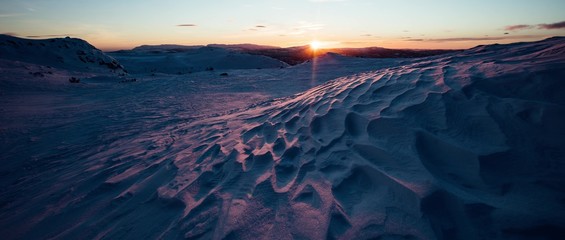 Sunset view from snowy hills
