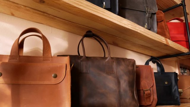 Bags show room. Genuine leather bags on the shelf. Tilt panoramic move