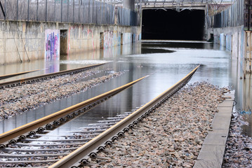 Flooded railway tracks in front of tunnel, Sweden.