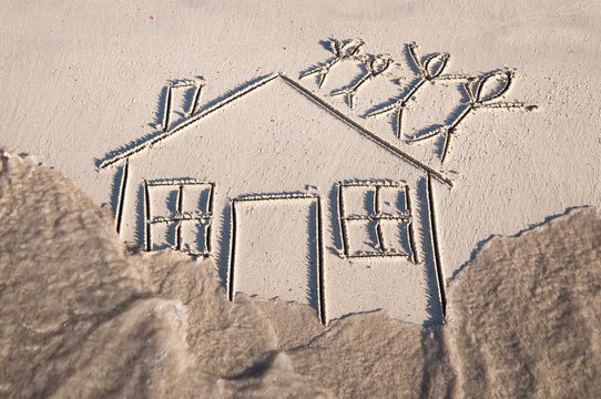 Family Of Stick Figures Standing On The Roof As Flood Waters Rush In Around Their House Drawn In The Sand