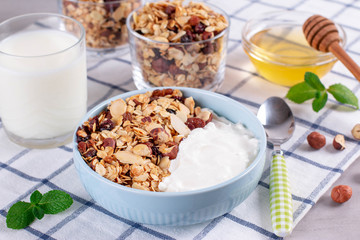 Delicious healthy Breakfast. Smoothie bowl with granola, bananas, kiwi and nuts.