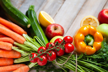 Concept of clean eating, healthy food, vegetarian and vegan diet. Natural organic fruits and vegetables. Wooden background, close up, copy space, flat lay, top view