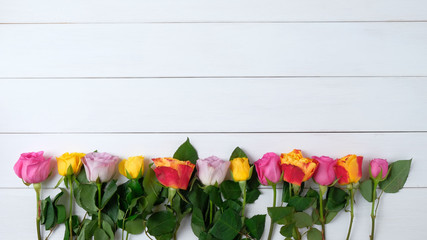 Fototapeta na wymiar roses flowers on a white wooden background