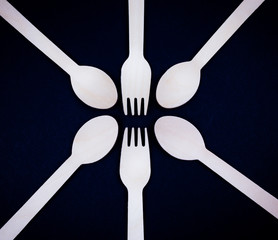 Eco wooden cutlery forks and spoons on a black background