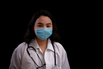 Latin female health worker with face mask and black background