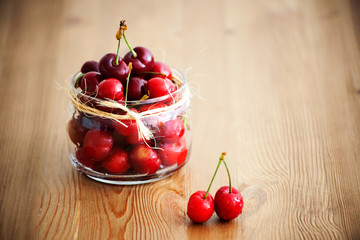 Red morello cherries - summer berries on a wooden table. Fresh red heart cherries. vitamins. Healthy nutrition