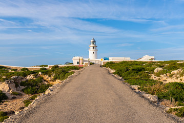 Fototapeta na wymiar The lighthouse of Cavalleria located at the northernmost point of Menorca island. Baleares, Spain