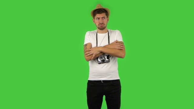 Confident guy froze and trying to keep warm. Green screen