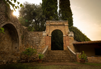 antique gate and wall in the Giardino delle Rose garden in San Quirico d'Orcia, Province of Siena, Tuscany, Italy