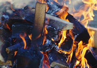 Bonfire. Orange flame of a fire. Burning birch tree in the fireplace. Bonfire on the grill with...