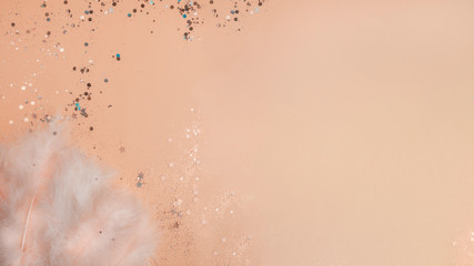 feathers on yellow background with glitters