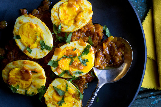 Directly above view of eggs in spicy tomato sauce