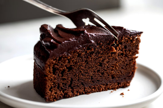 Close up view of chocolate cake cutting with fork