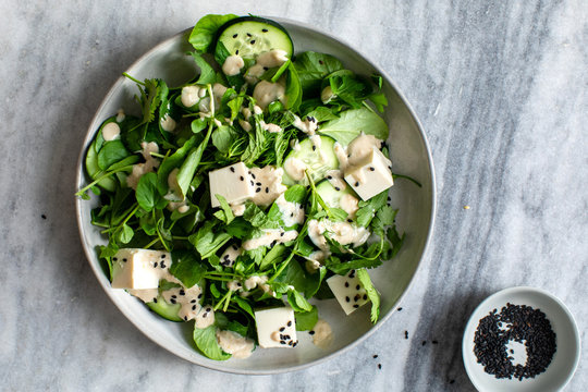 Directly above view of herb salad with tofu and sesame