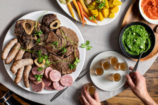 Bollito misto served with vegetables, dipping sauces and endive salad