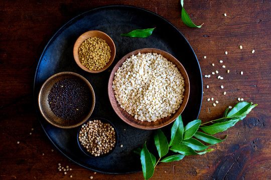 Variety of Indian spices arranged in different bowls