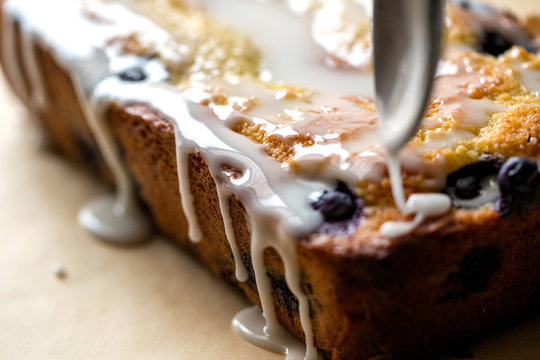 Close up view of berry cake drizzling with cream