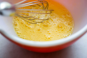 Directly above view of whisking eggs