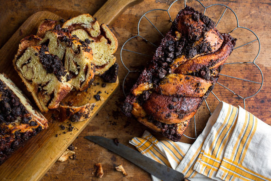 Directly above view of sliced chocolate babka on wooden board