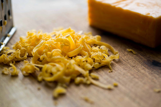 Close up view of grated cheddar cheese