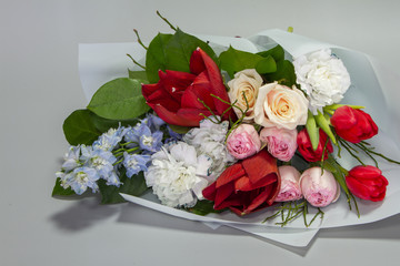 Beautiful summer bouquet in bright colors, gray backdrop, selective focus