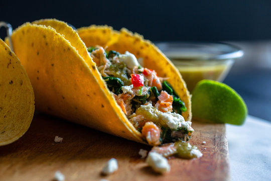Selective focus of tacos on wooden board