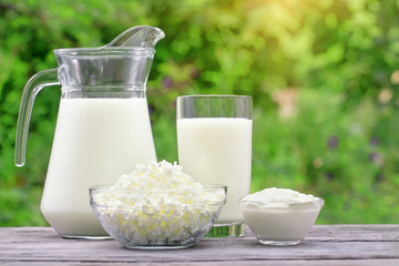 Milk curd and sour cream in glass bowl on wooden table