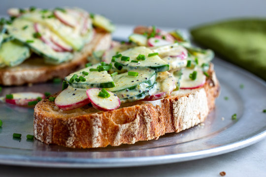 Selective focus of salad topped with cucumber and radish in plate