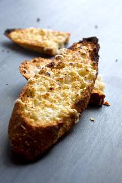 Selective focus of toasted garlic bread on wooden surface