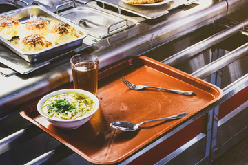 food bought in the dining room on a tray, the front and back background is blurred with a bokeh...