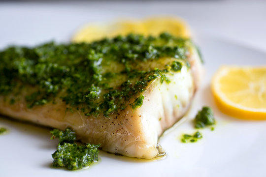 Selective focus of broiled fish with chermoula