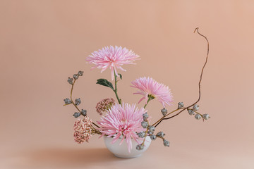 Modern sculptural flowers in vase, studio photograph, isolated, pink background