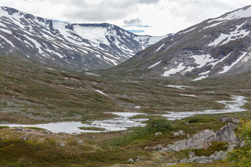 Norwegian summer landscape, wonderful view of snow-capped mountains with clean, cold air in summer, selective focus.