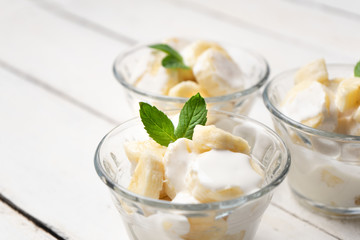 Banana with sour cream on white background