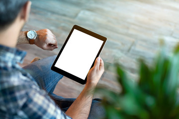 Man hold tablet computer with isolated screen in his hand, and looking what time o'clock. Clipping path.