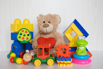  plush bear with different plastic toys